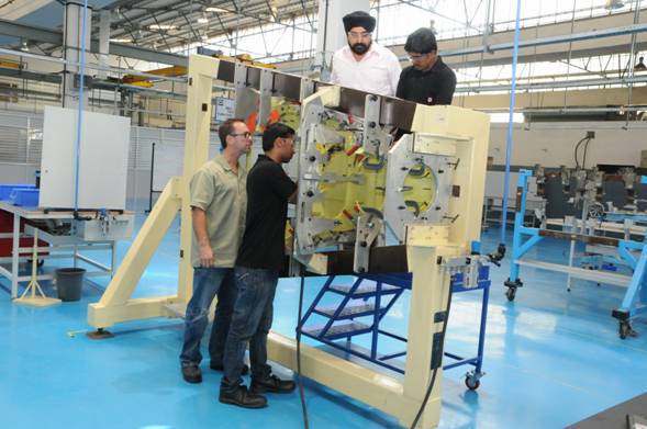 employees install lower frame into Bell 407