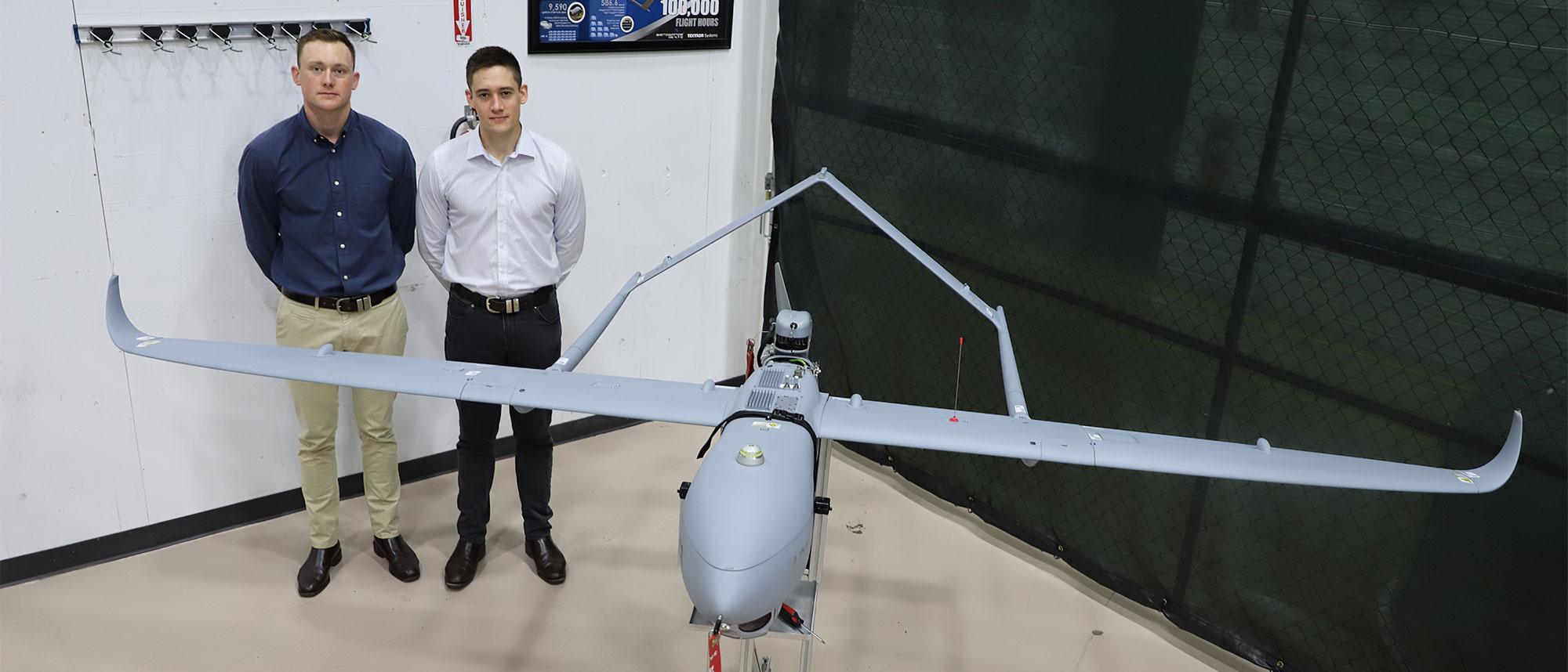 Australian Cadets Standing Next to Aerosonde