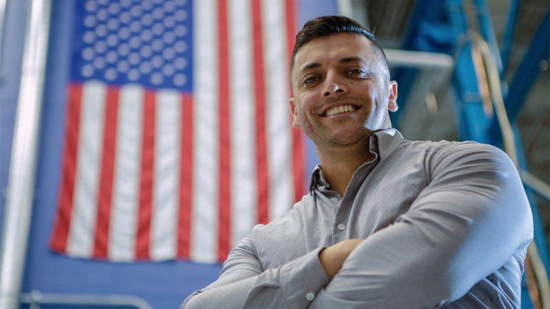 Military community with US flag and veteran worker