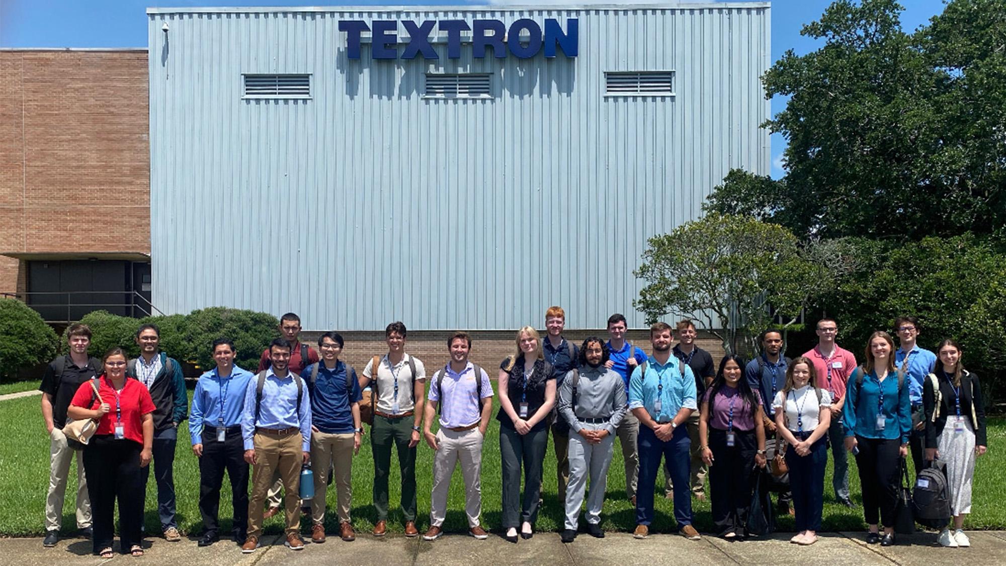Interns posing in front of Textron Systems building