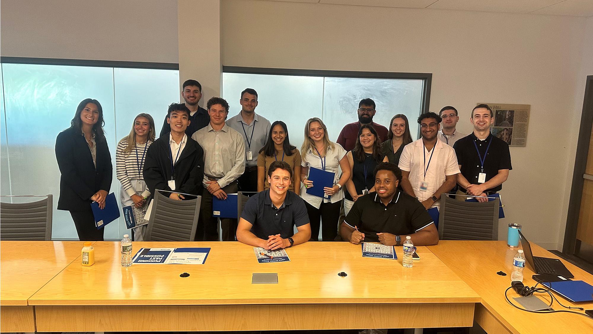 Interns posing in a conference room at Textron Systems' Wilmington facility