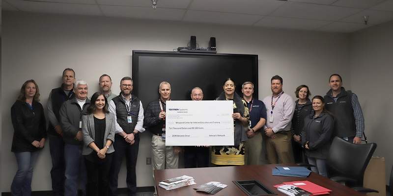 Pictures volunteers from Family Day presenting a check to MCVET.